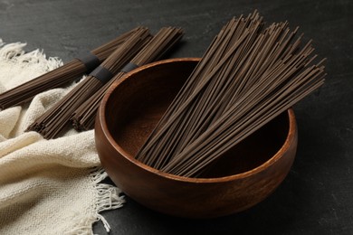 Photo of Uncooked buckwheat noodles (soba) on black table
