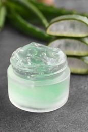 Photo of Jar of natural aloe gel on grey table