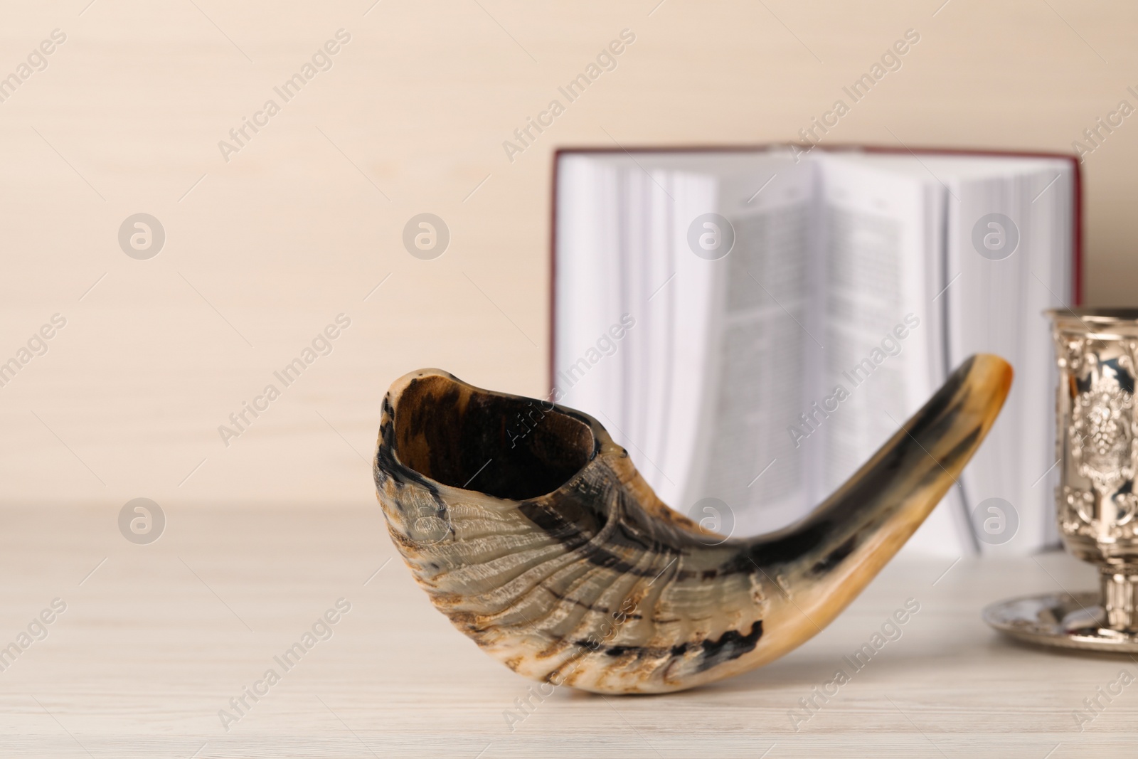 Photo of Composition with Rosh Hashanah holiday symbols on light beige wooden table