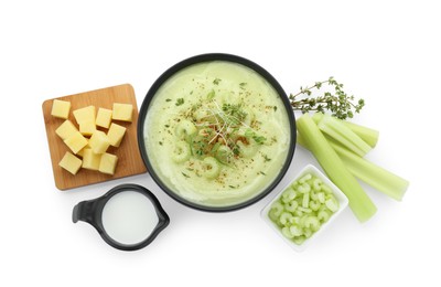 Photo of Bowl of delicious celery soup and ingredients isolated on white, top view