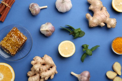 Photo of Flat lay composition with fresh products on blue background. Natural antibiotics