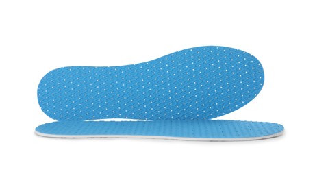 Photo of Pair of light blue insoles on white background