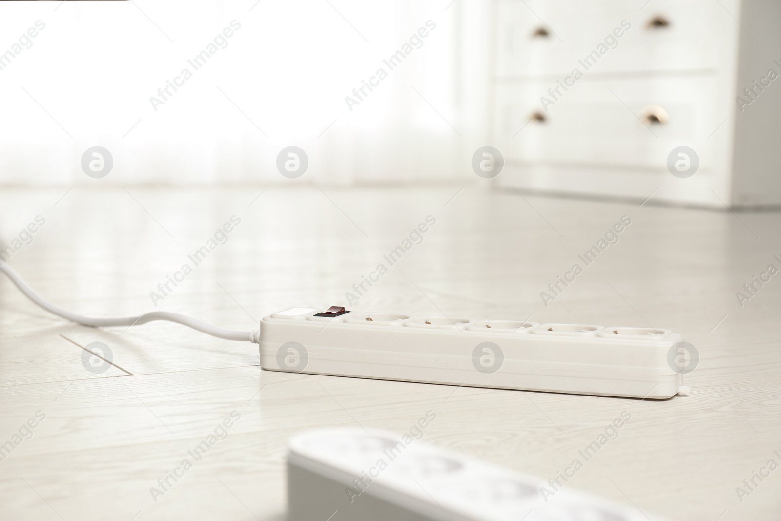 Photo of Extension cords on floor indoors, space for text. Electrician's professional equipment