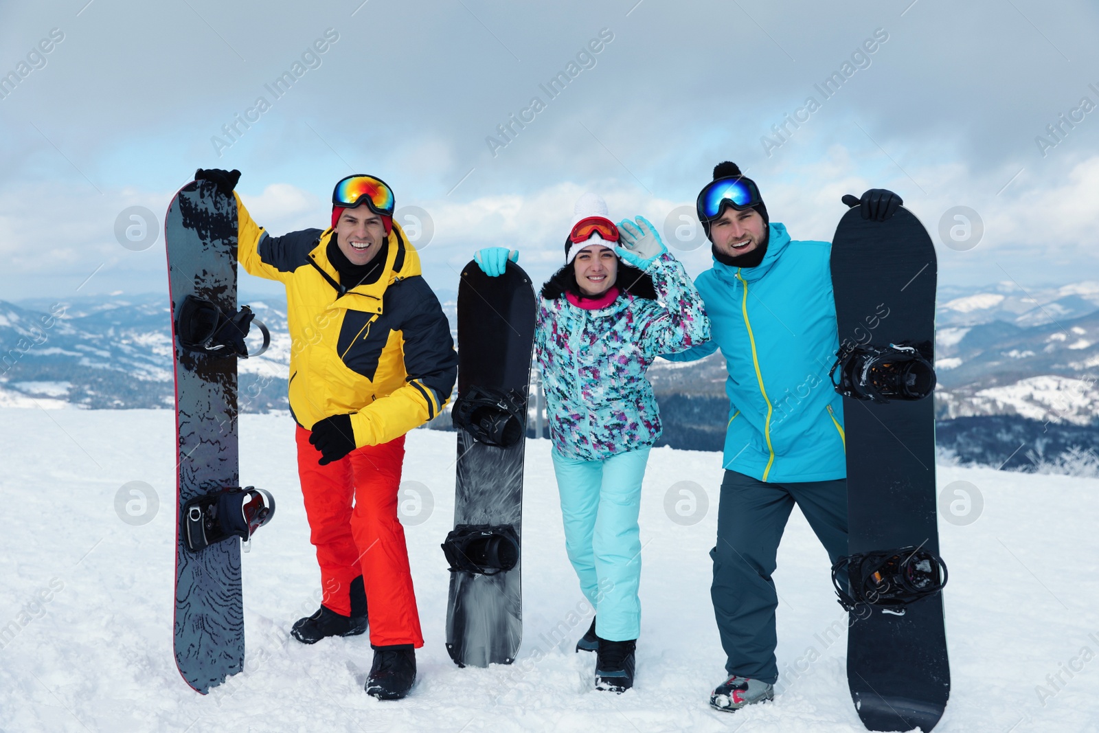 Photo of Group of friends with equipment in snowy mountains. Winter vacation