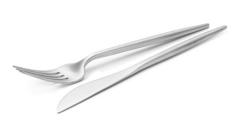 Photo of Shiny silver fork and knife isolated on white. Luxury cutlery