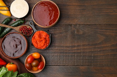 Photo of Different marinades and products on wooden table, flat lay. Space for text