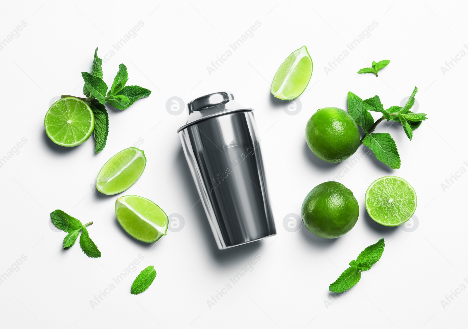 Photo of Flat lay composition with lime, mint and shaker on light background. Refreshing beverage ingredients