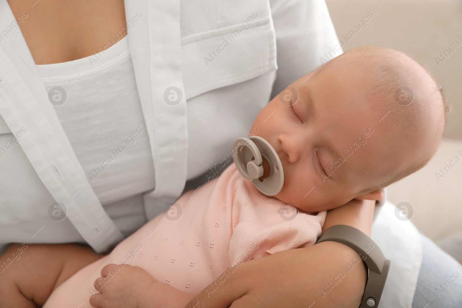 Photo of Mother with her cute sleeping baby at home, closeup