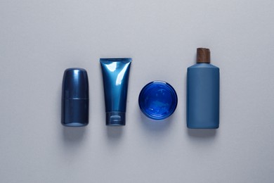 Photo of Facial cream and other men's cosmetic products on light grey background, flat lay