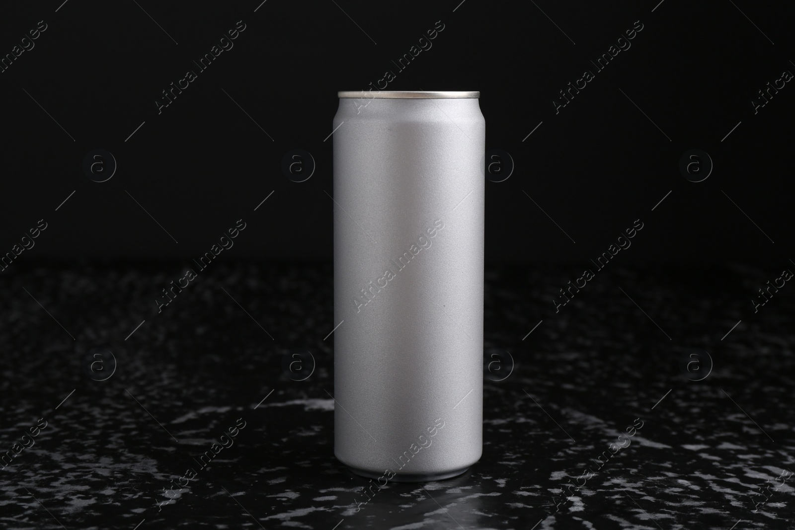 Photo of Energy drink in can on black textured table