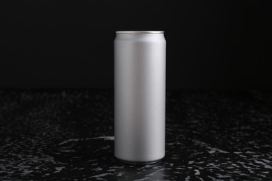 Photo of Energy drink in can on black textured table