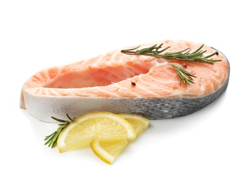 Fresh salmon steak with rosemary and lemon on white background