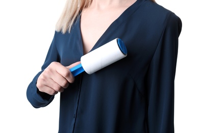 Young woman cleaning blouse with lint roller on white background