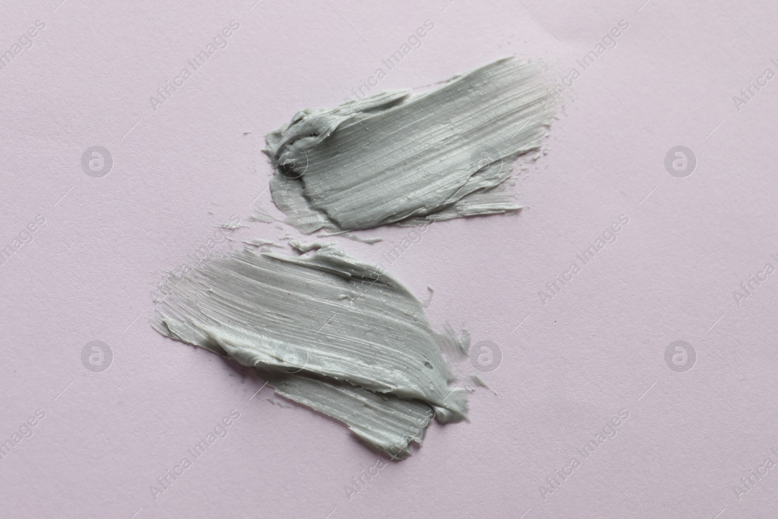 Photo of Sample of face mask on pink background, top view