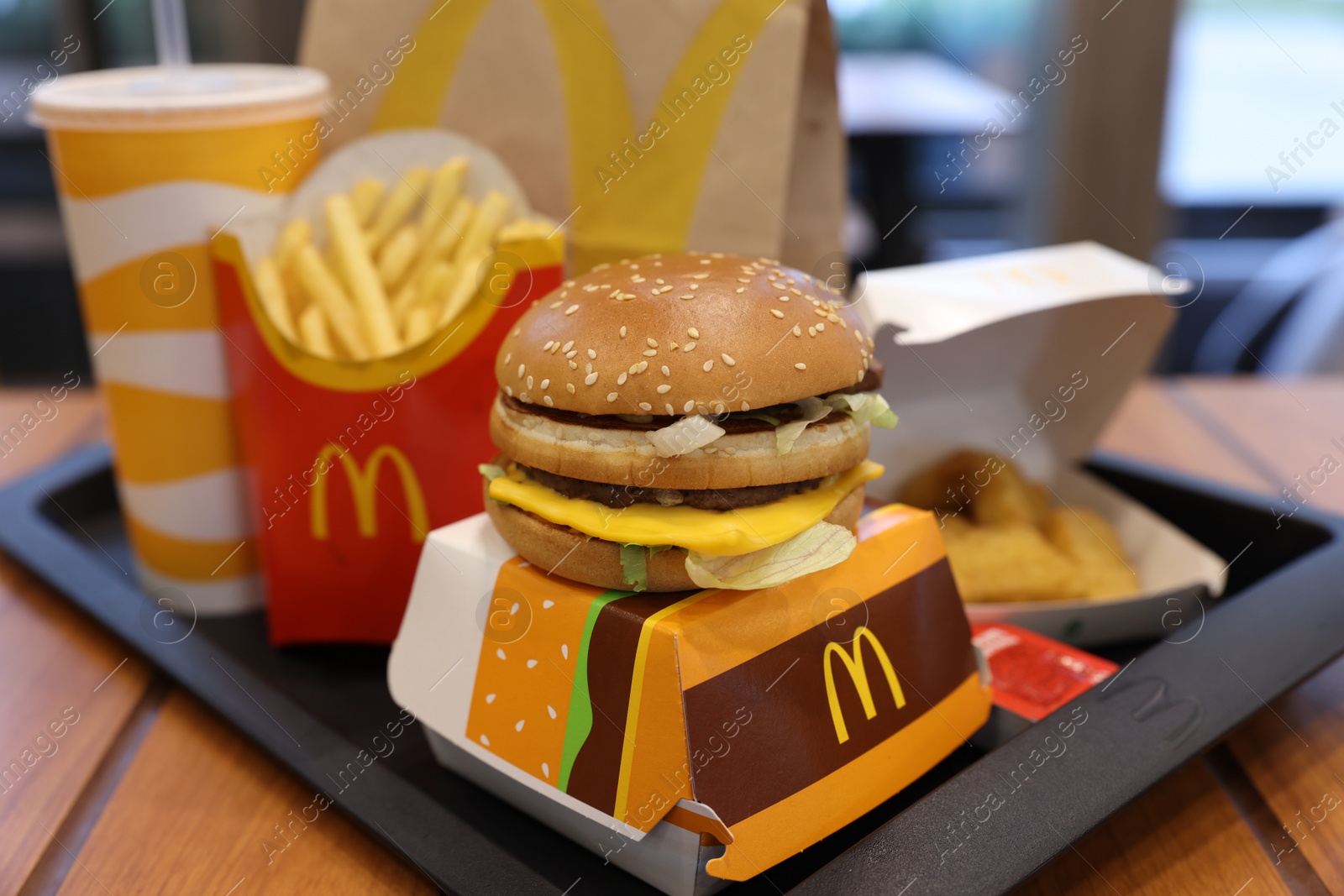 Photo of Lviv, Ukraine - October 9, 2023: McDonald's menu on wooden table in restaurant