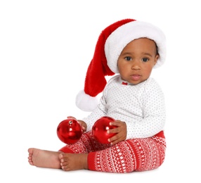 Festively dressed African-American baby with Christmas decorations on white background