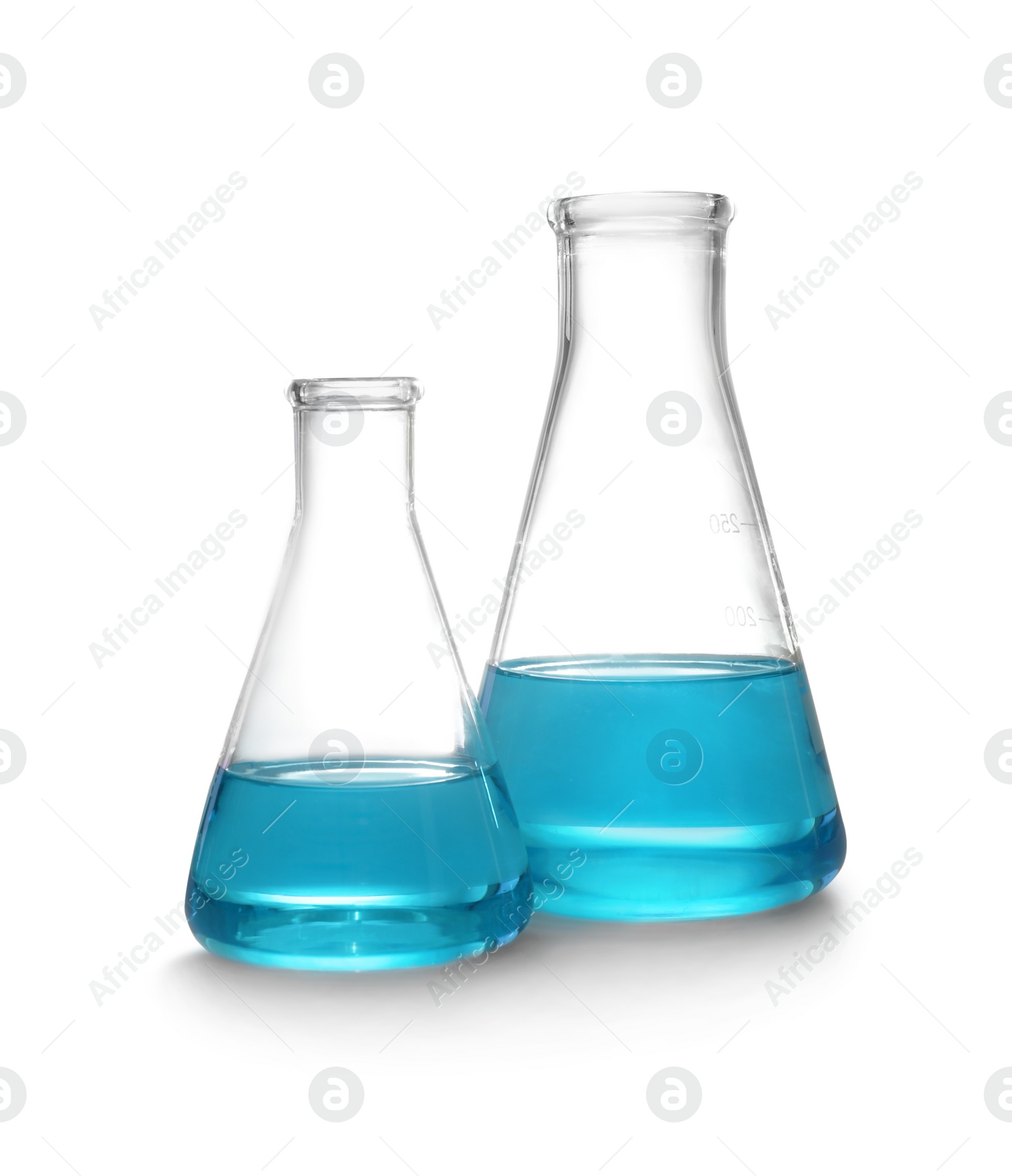 Photo of Laboratory glassware with liquid on white background. Solution chemistry