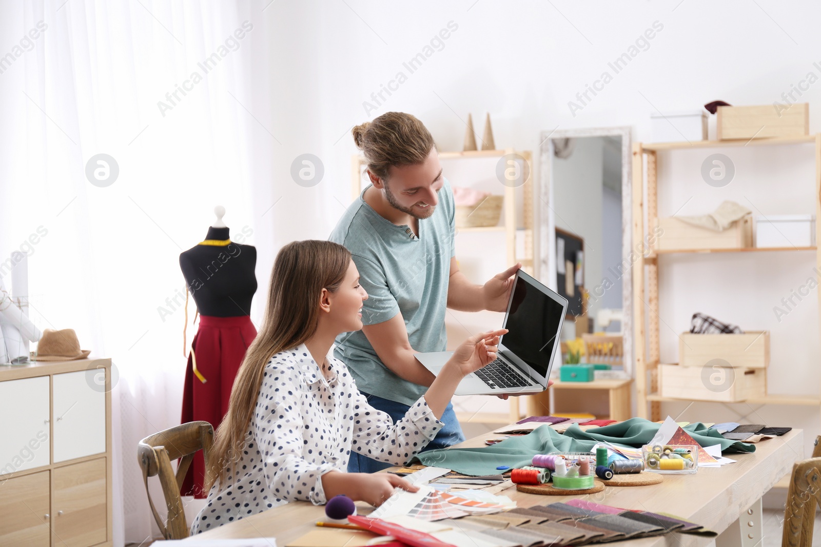 Photo of Fashion designers creating new clothes in studio