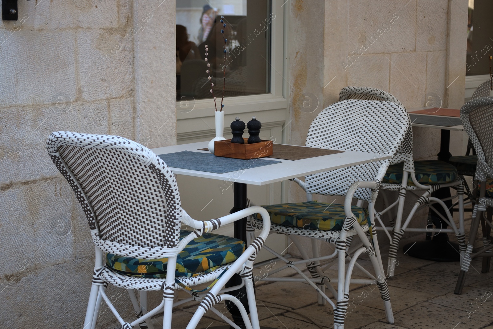 Photo of Outdoor cafe with white chairs and table