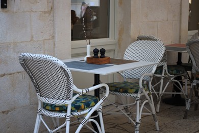 Outdoor cafe with white chairs and table
