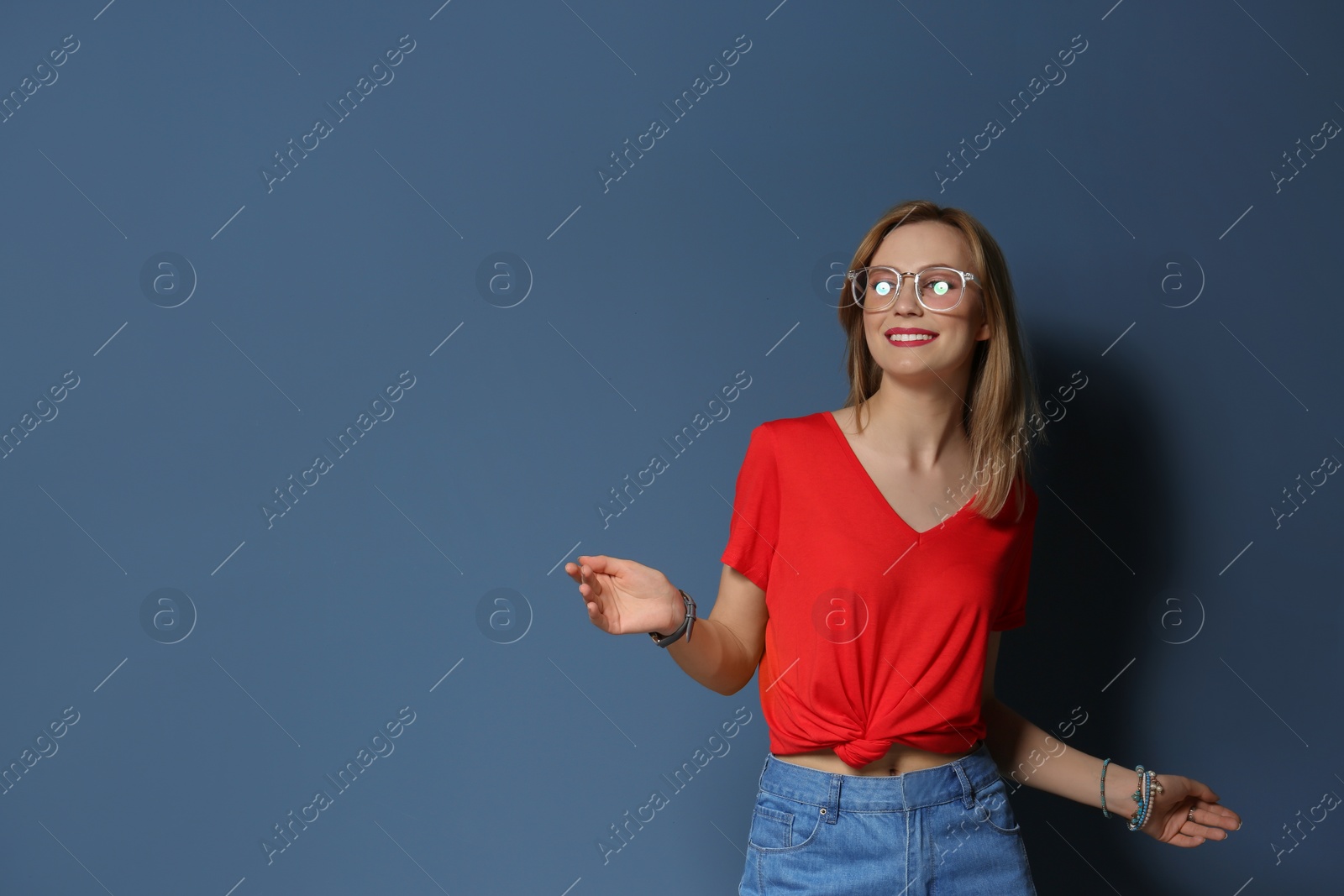 Photo of Attractive young woman in stylish outfit on color background