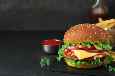 Photo of Delicious burger with beef patty on dark table, space for text