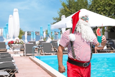 Authentic Santa Claus with cocktail near pool at resort