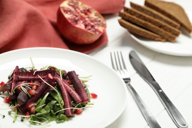 Photo of Delicious fresh carrot salad served on white wooden table, closeup