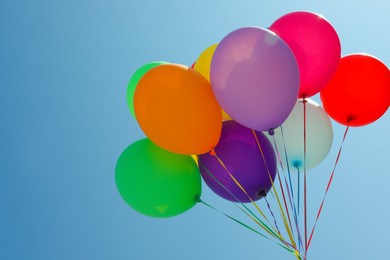 Bunch of colorful balloons against blue sky