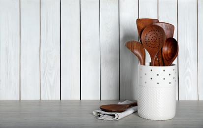 Set of kitchen utensils on table, space for text