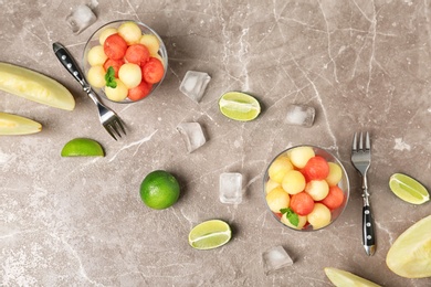 Photo of Flat lay composition with melon and watermelon balls on brown marble table