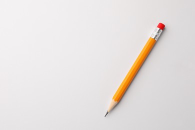 Photo of Sharp graphite pencil with eraser on white background, top view. Space for text