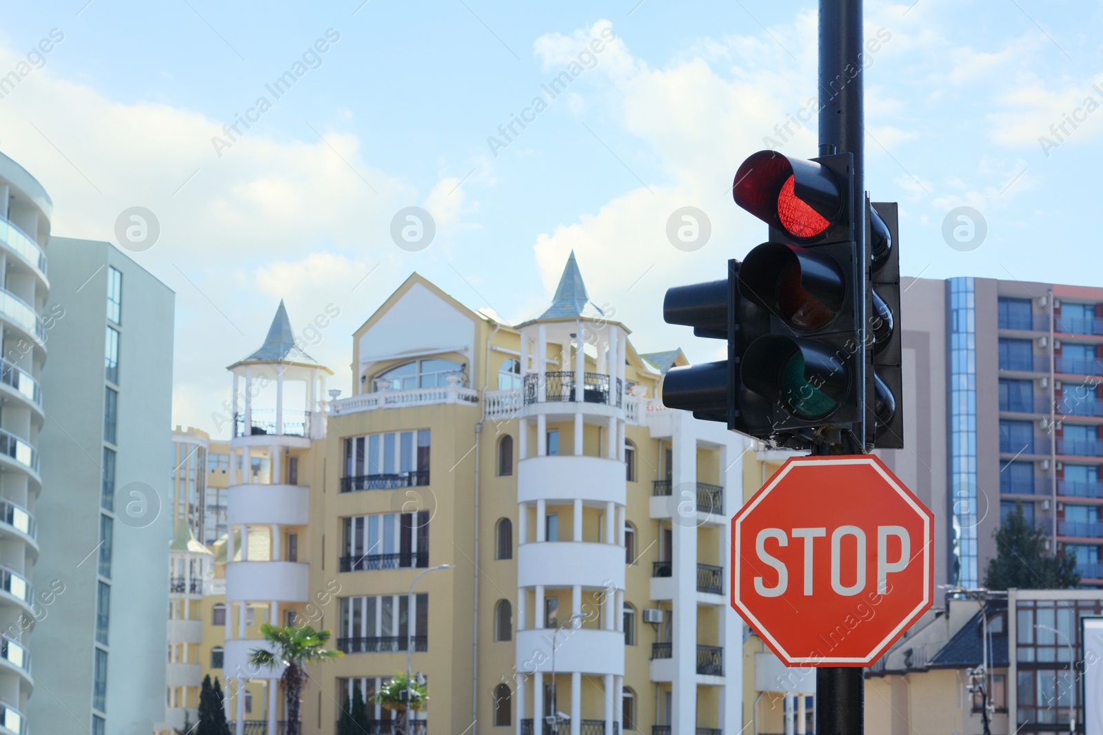 Photo of Post with sign Stop near traffic lights outdoors, space for text