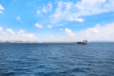 Photo of Beautiful view of ship in sea with city on background