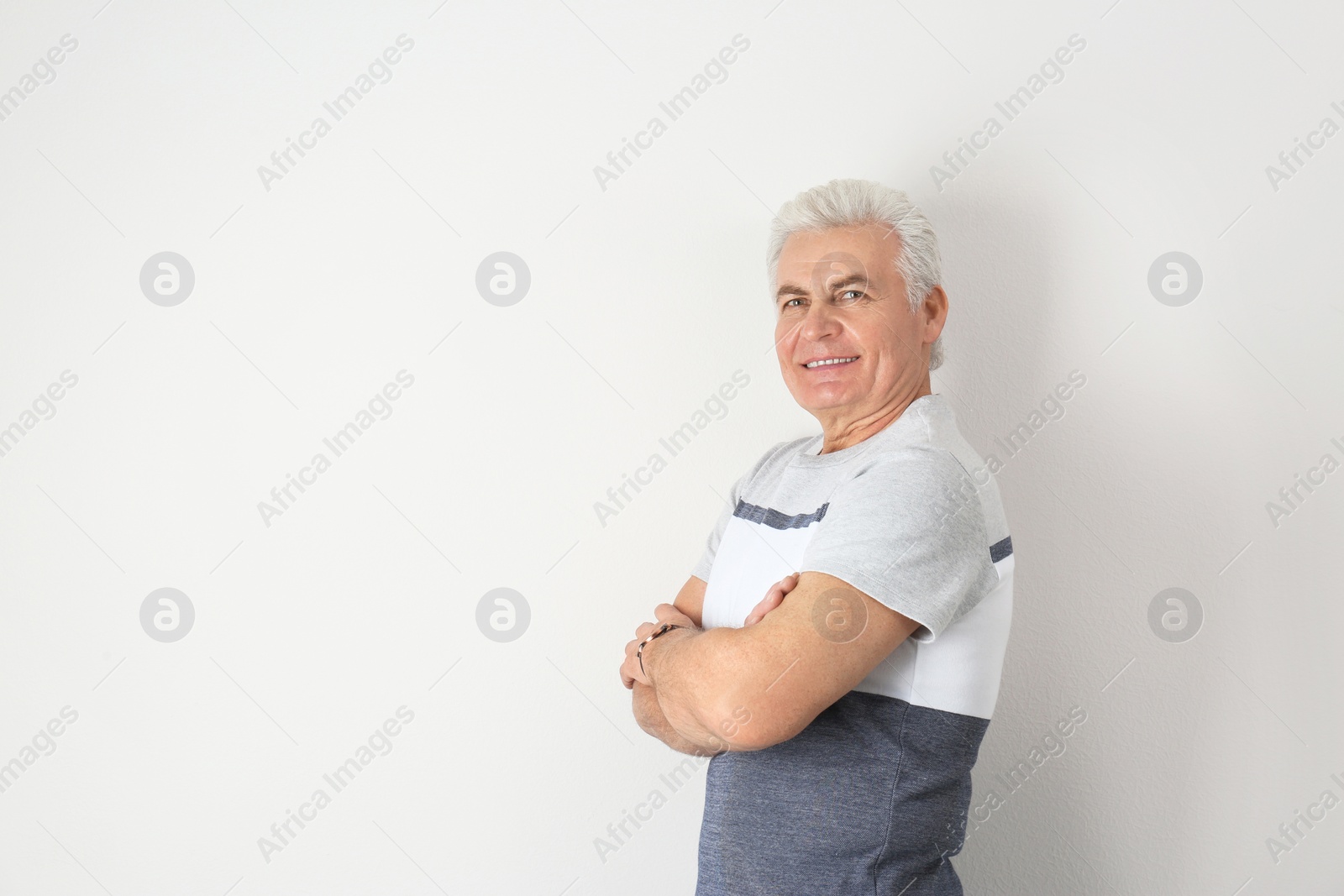 Photo of Portrait of handsome mature man on light background. Space for text