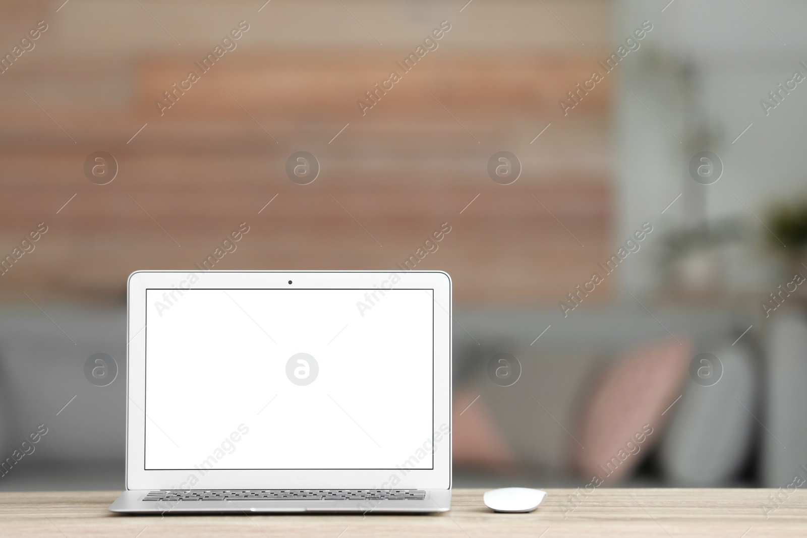 Photo of Laptop with blank screen on table indoors. Space for text