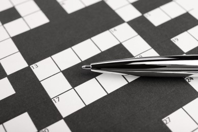 Photo of Pen and blank crossword, closeup. Space for text