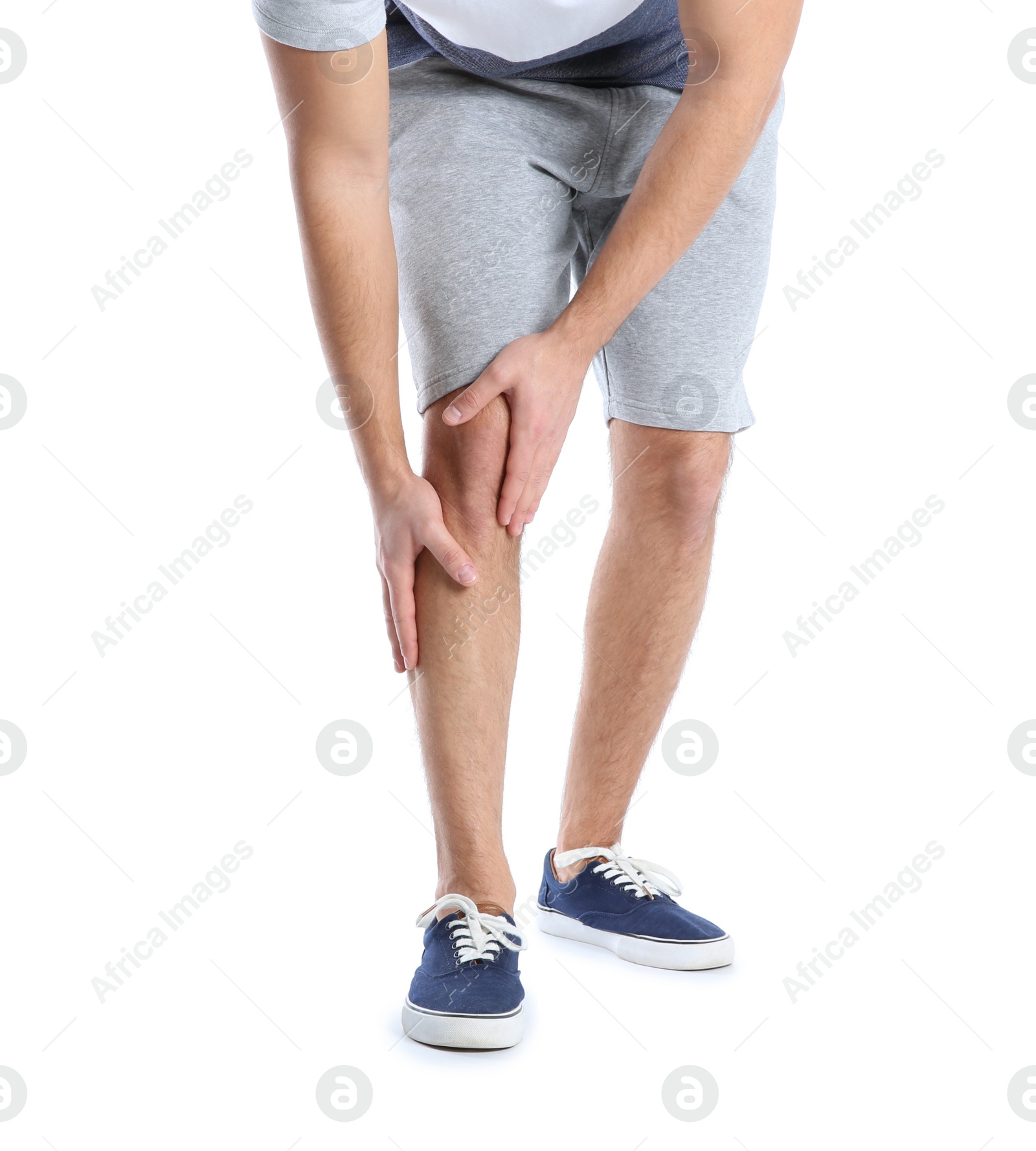 Photo of Man suffering from leg pain on white background, closeup