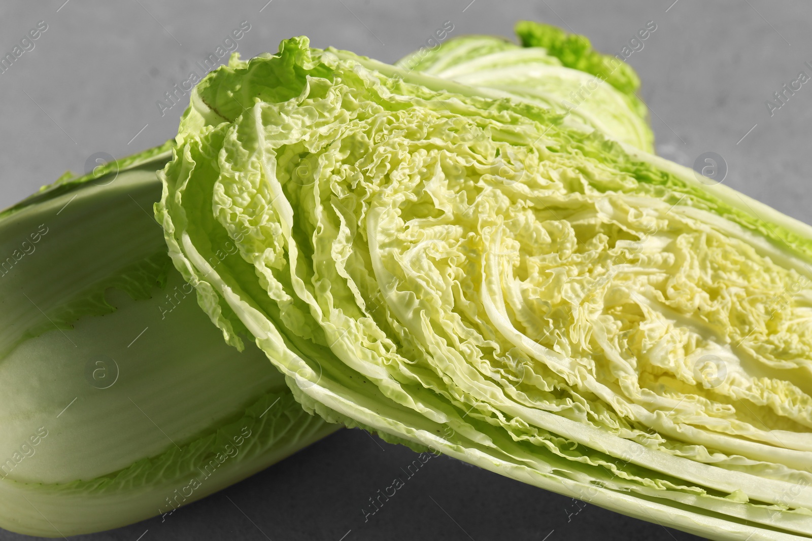 Photo of Fresh ripe Chinese cabbages on gray table, closeup