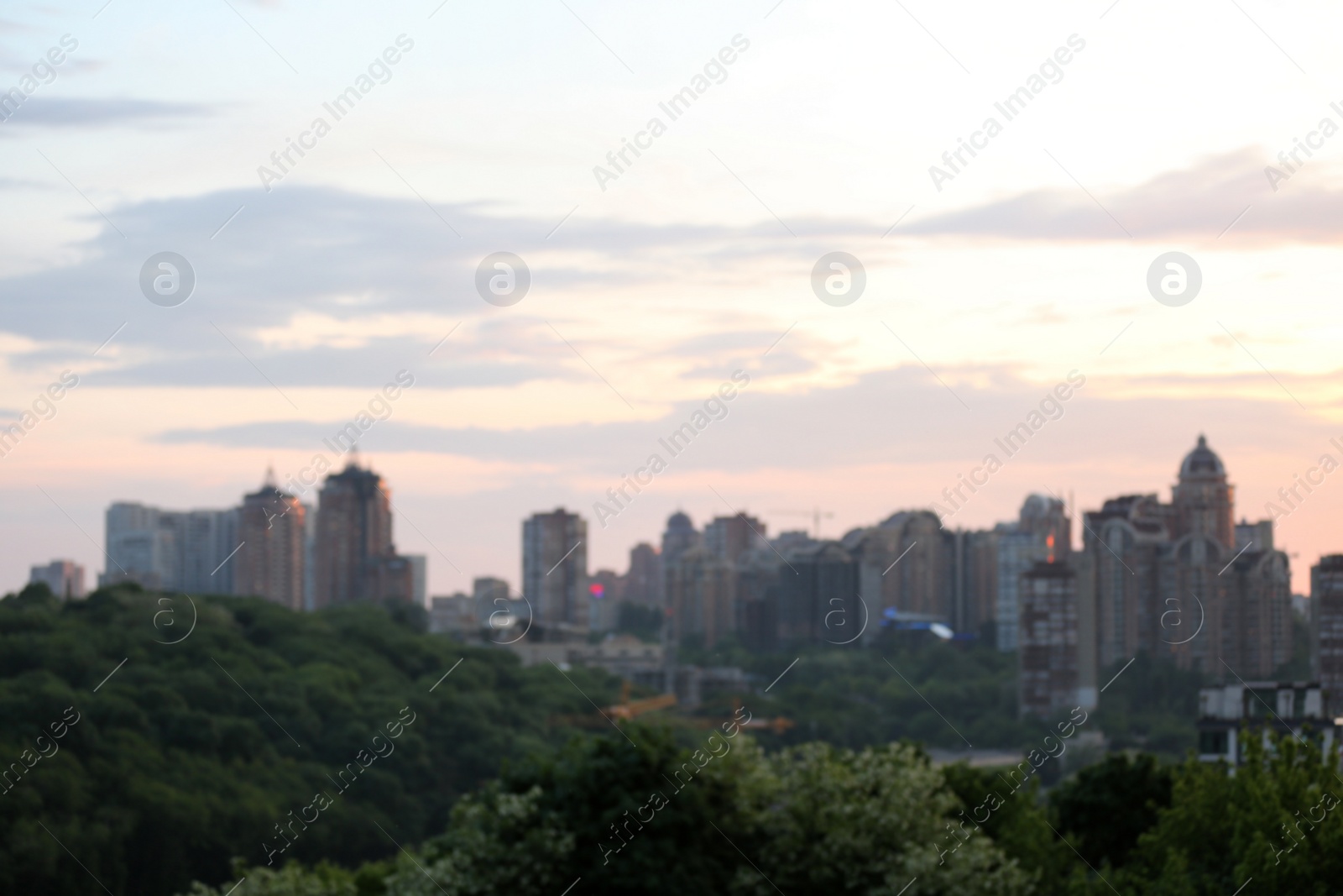 Photo of KYIV, UKRAINE - MAY 23, 2019: City district with modern buildings at sunset, blurred view