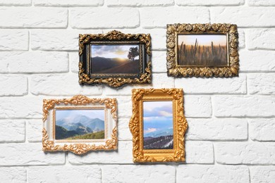 Vintage frames with photos of beautiful landscapes hanging on white brick wall