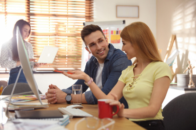 Photo of Professional designers working together in modern office