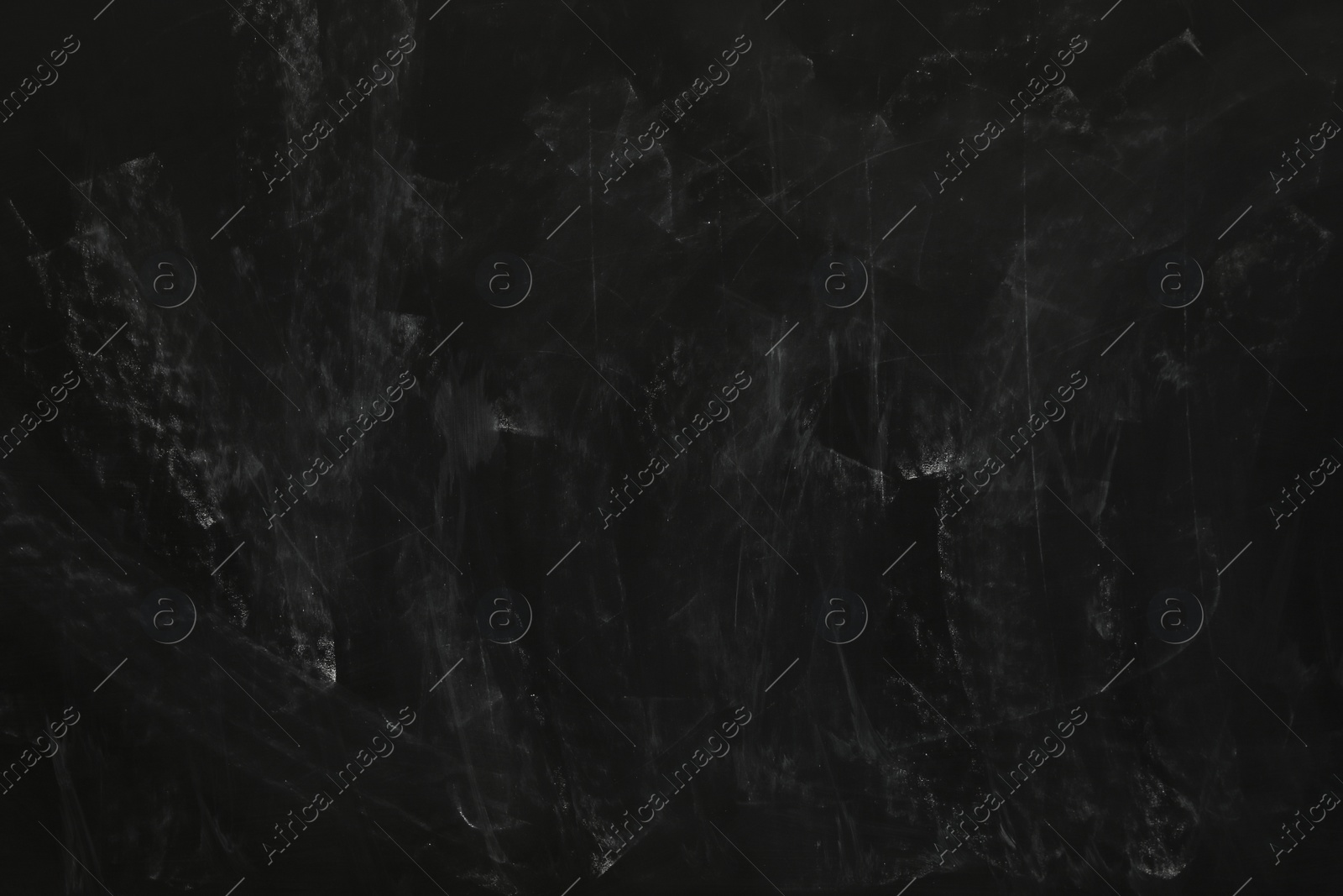 Photo of Chalk rubbed out on black chalkboard as background, closeup. Space for text