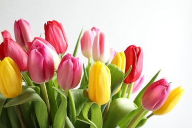 Photo of Beautiful bouquet of bright tulip flowers on white background