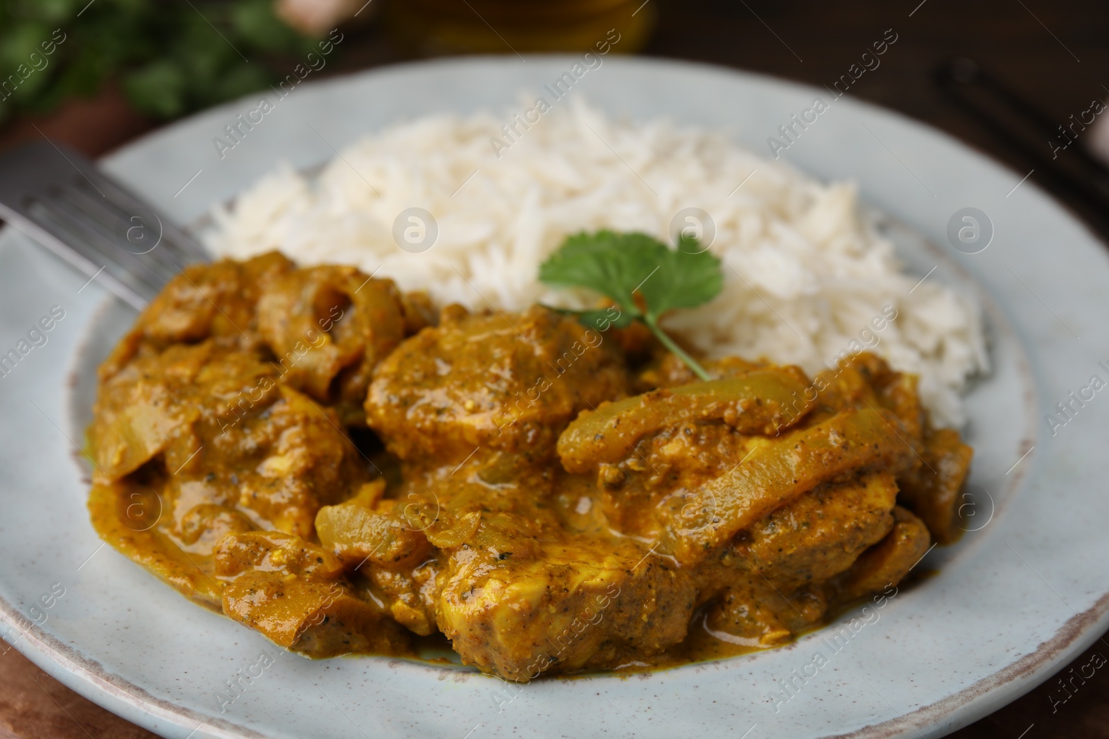 Photo of Delicious chicken curry with rice on table, closeup