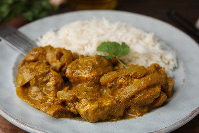 Photo of Delicious chicken curry with rice on table, closeup