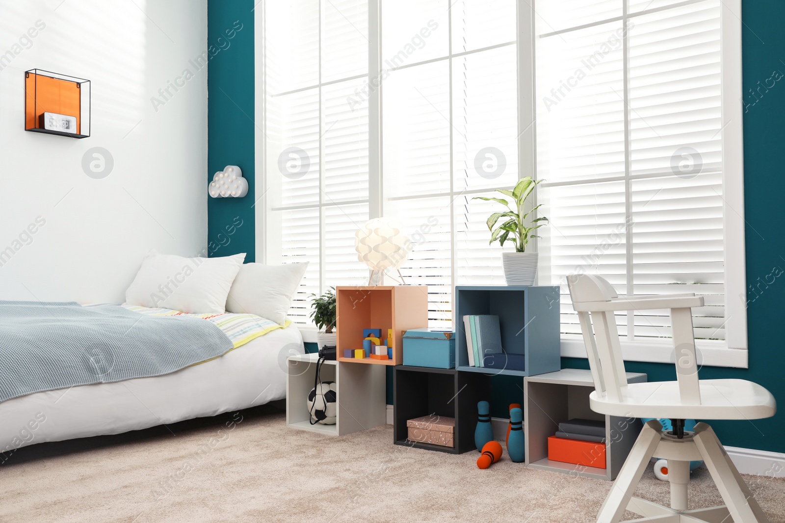 Photo of Modern child room interior with comfortable bed near window