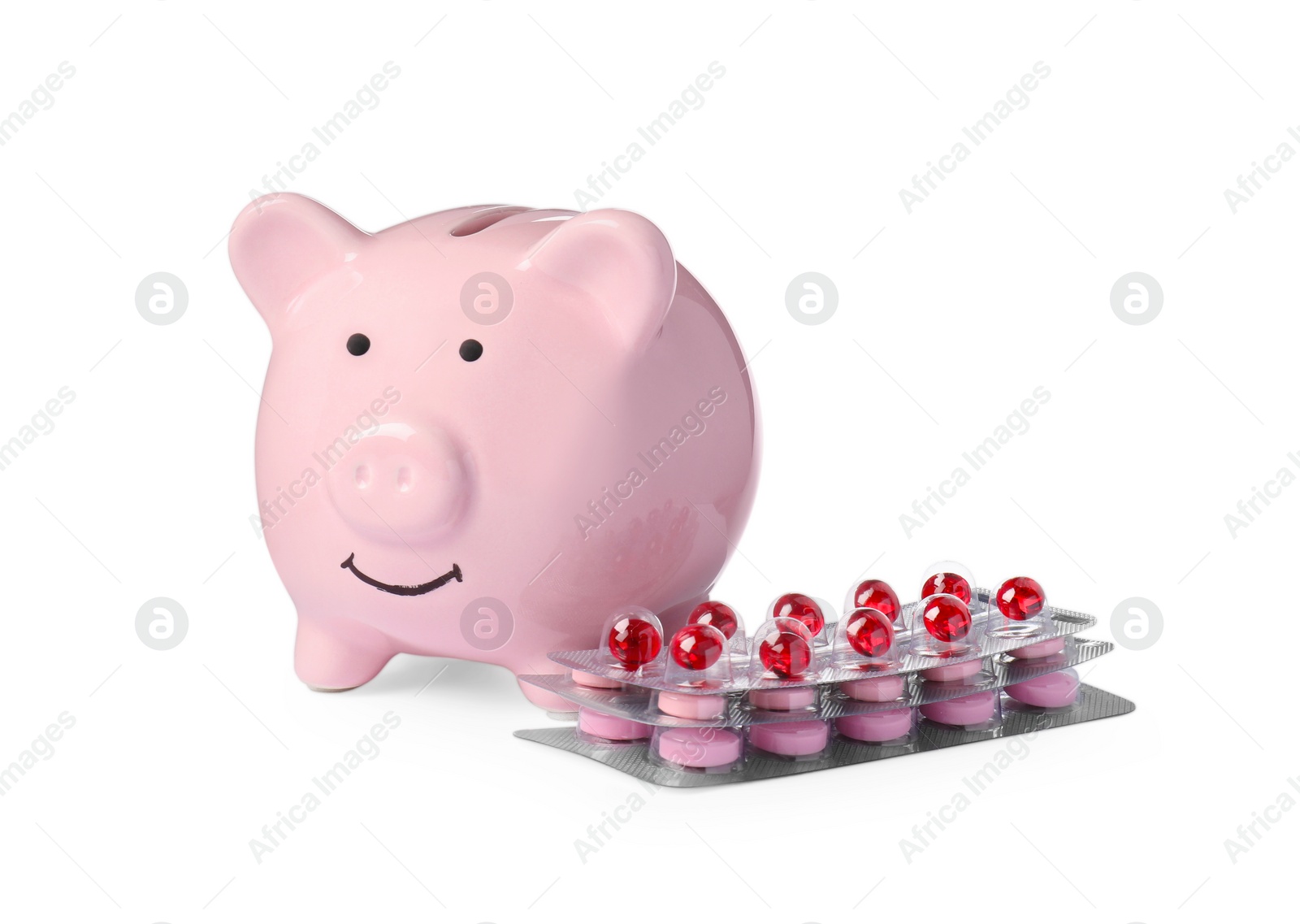 Photo of Piggy bank and pills on white background. Medical insurance