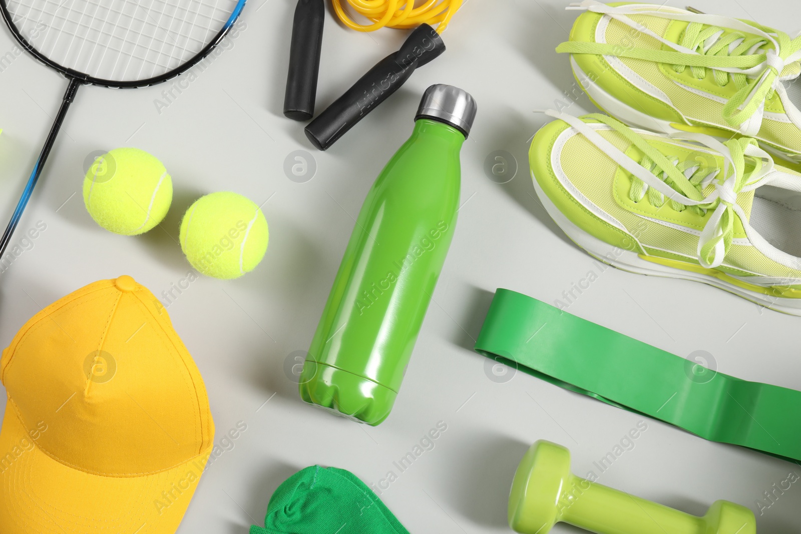 Photo of Different sports equipment on light grey background, flat lay