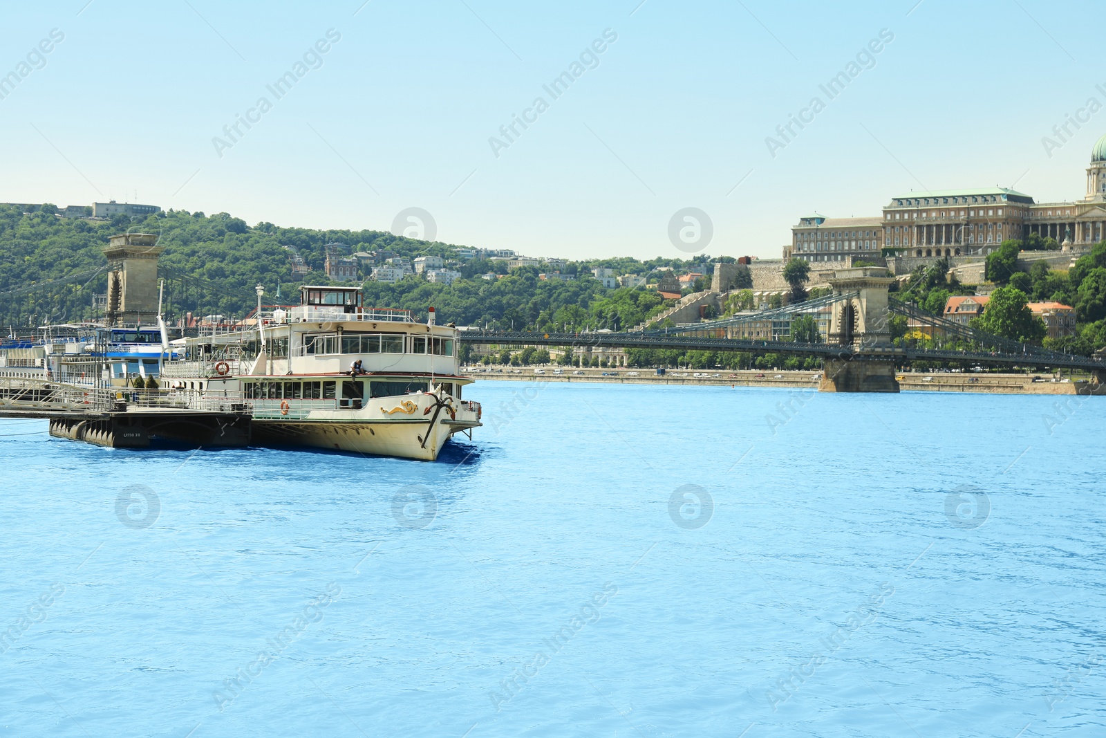 Photo of BUDAPEST, HUNGARY - JUNE 18, 2019: Beautiful view with Buda Castle, Szechenyi Chain Bridge and tour boat on Danube river